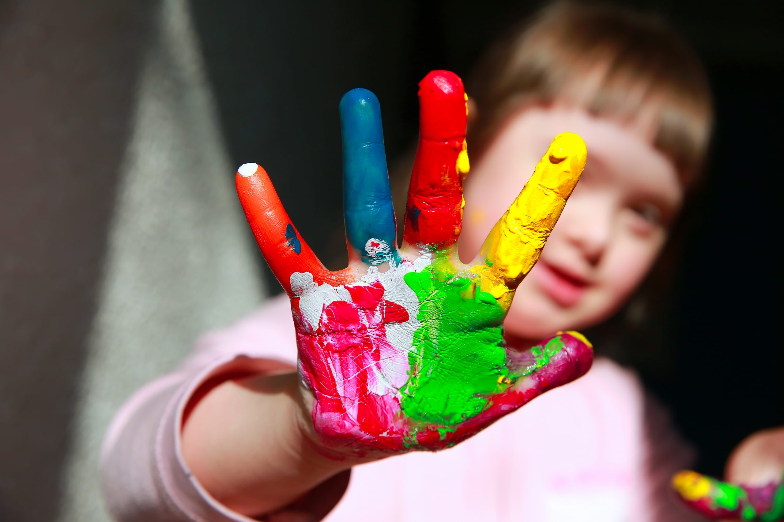 Cute little girl with painted hands